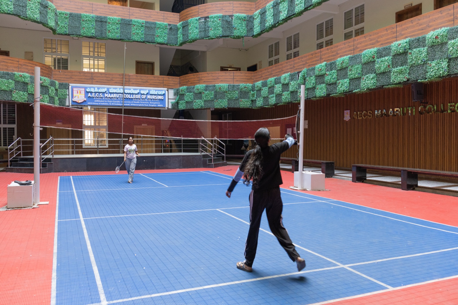 Students using the AECS campus sports court during college activities