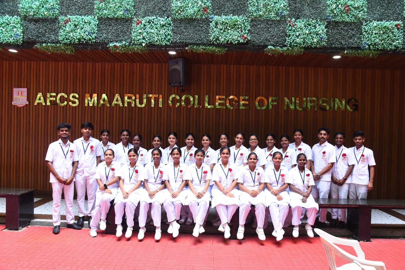 AECS nursing students in uniform seated together during a college event