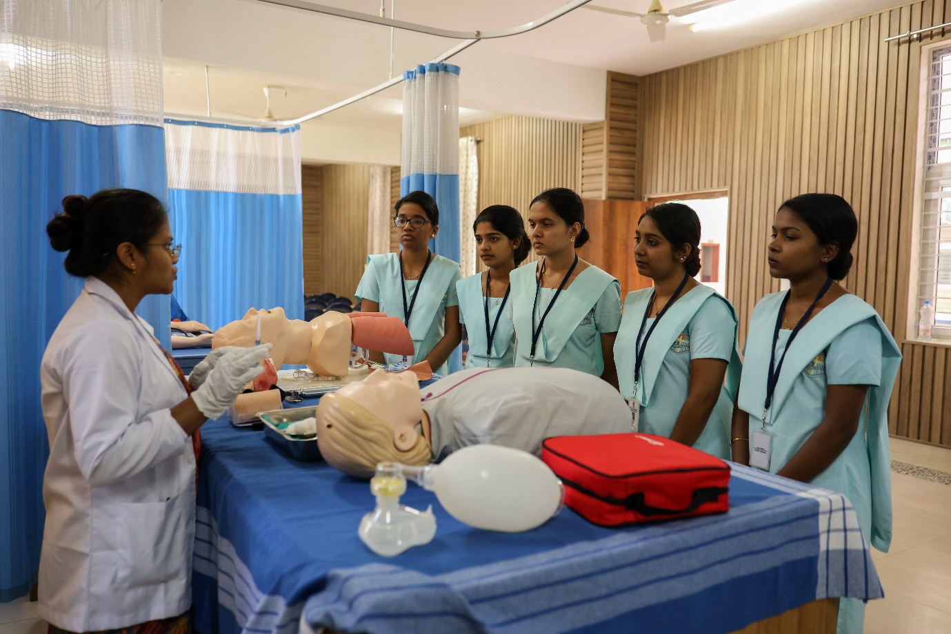 Skill lab with nursing students practising patient care on a mannequin